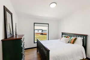 Bedroom with LVP floors and queen bed