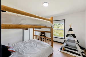 Bedroom featuring queen bunk beds and LVP flooring
