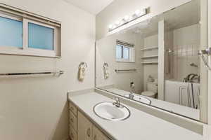 Full bath featuring vanity and toilet