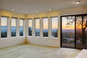 Carpeted spare room featuring a textured ceiling, recessed lighting, and crown molding
