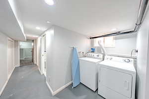 Laundry area featuring independent washer and dryer, recessed lighting, and a textured ceiling