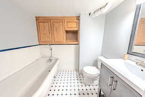 Full bath featuring a bath, vanity, and tile patterned floors