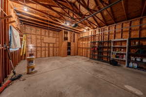 Miscellaneous room with a garage and concrete floors