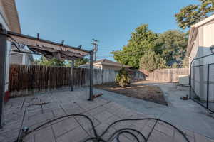 Fenced backyard featuring a patio