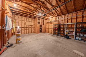 Misc room featuring a garage and concrete floors
