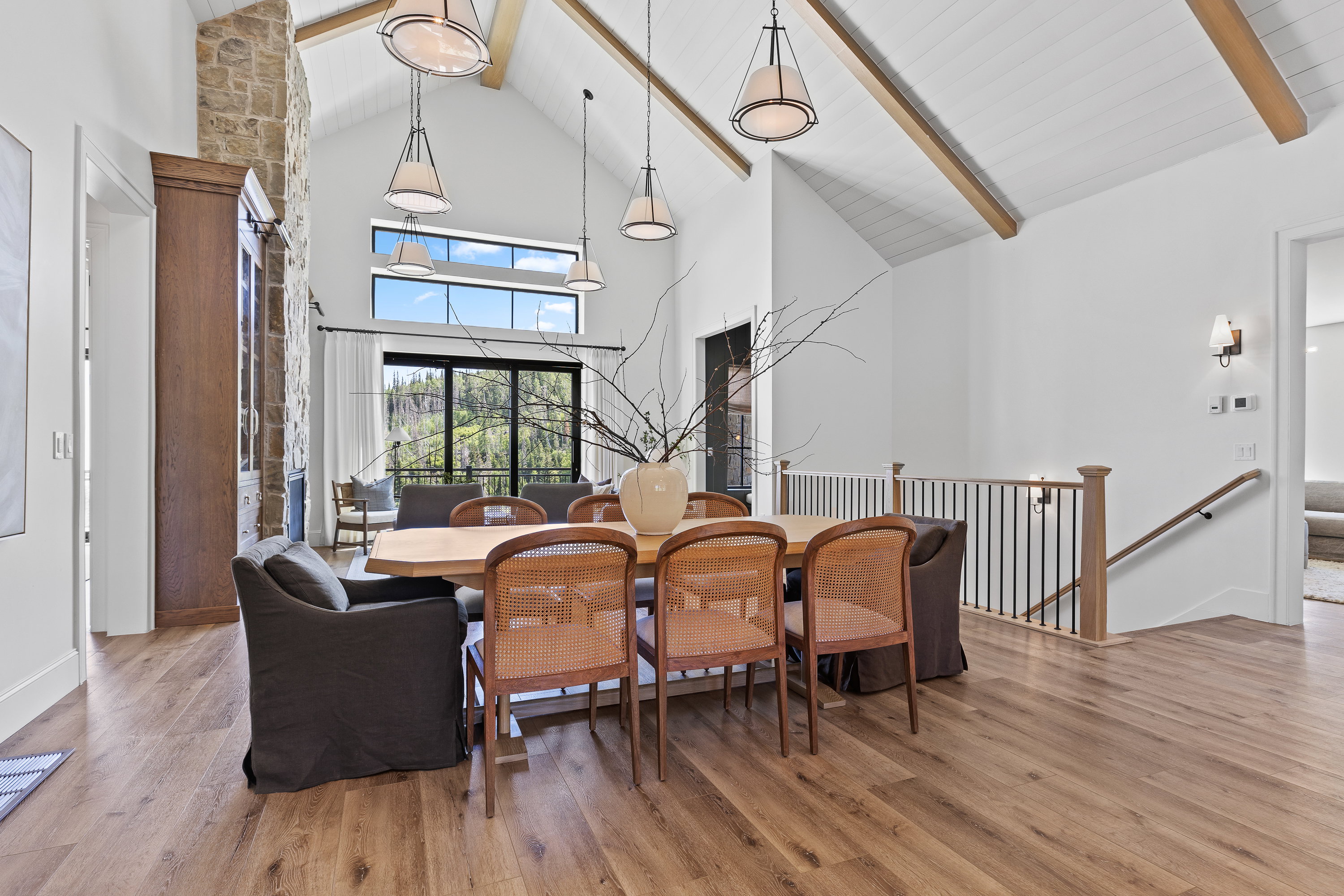 Dining area featuring high vaulted ceiling, beamed ceiling, and wood finished floors