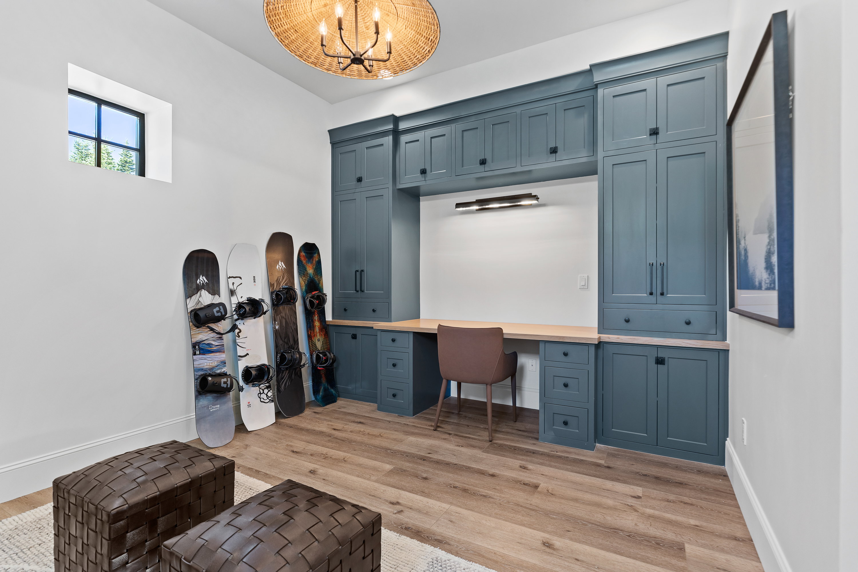 Office with a chandelier, light wood finished floors, and built in study area