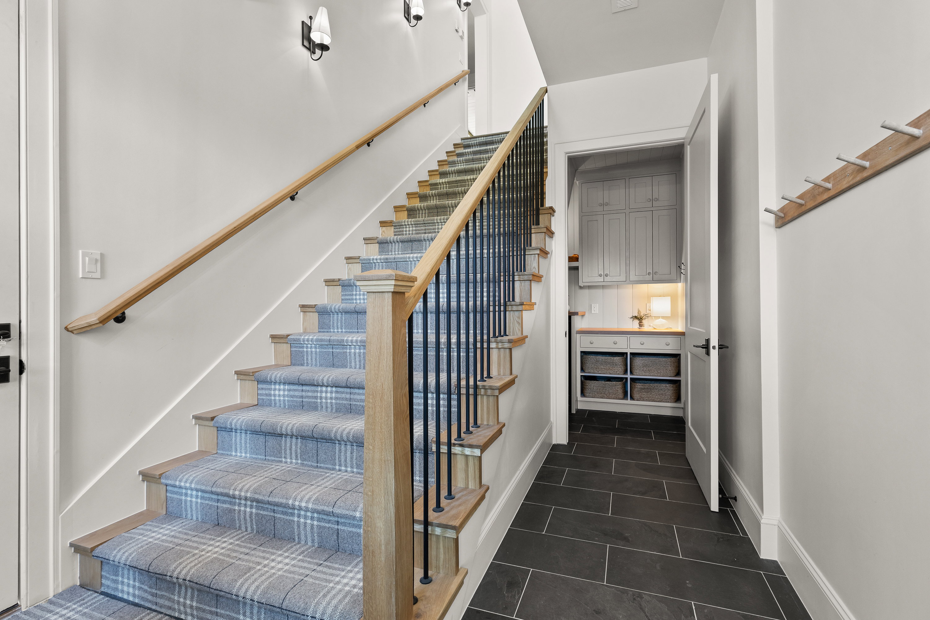 Stairs with tile patterned flooring and baseboards