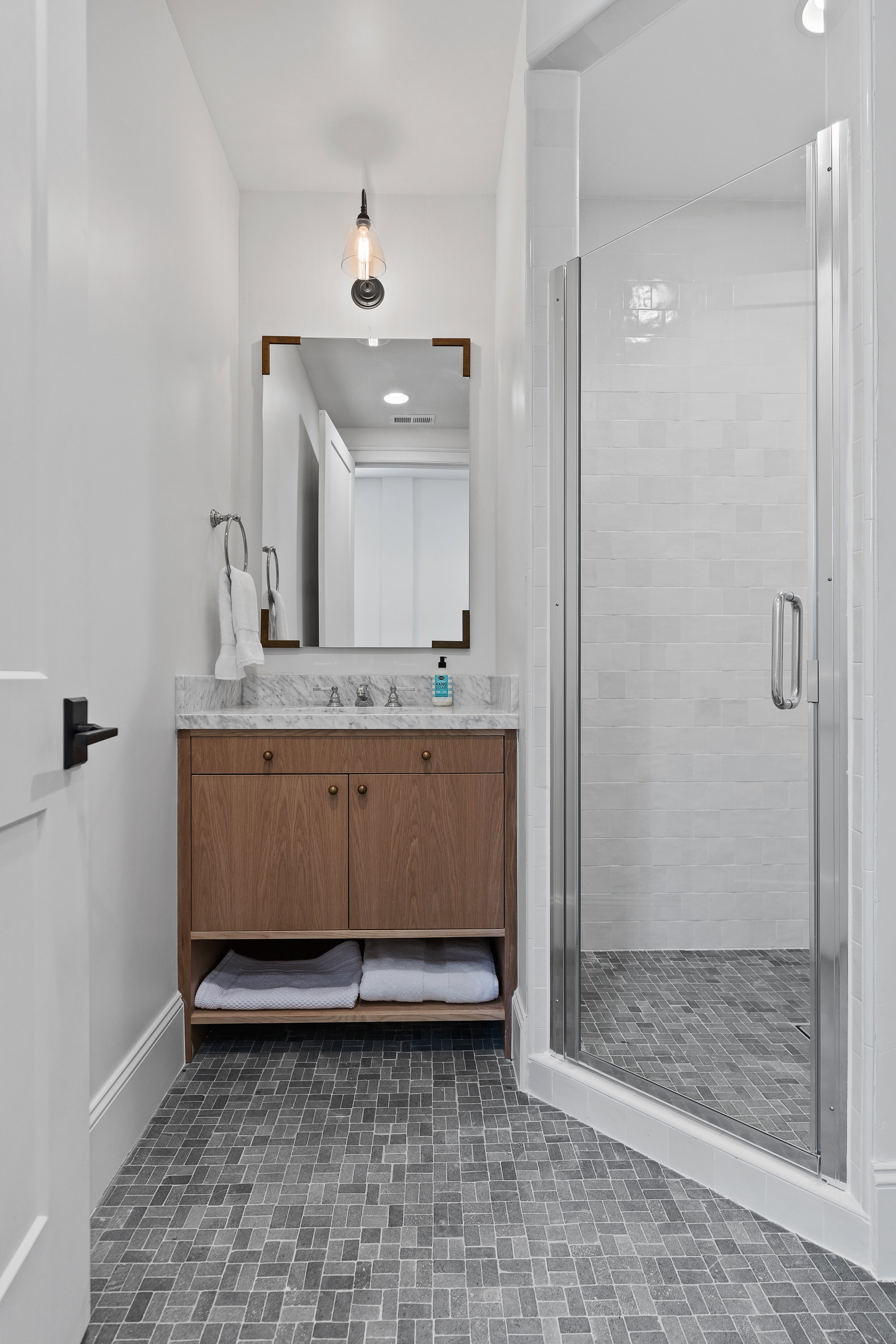 Bathroom featuring vanity and a shower stall