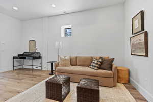 Living room with wood finished floors and recessed lighting