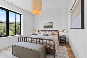 Bedroom featuring light wood-style flooring and multiple windows