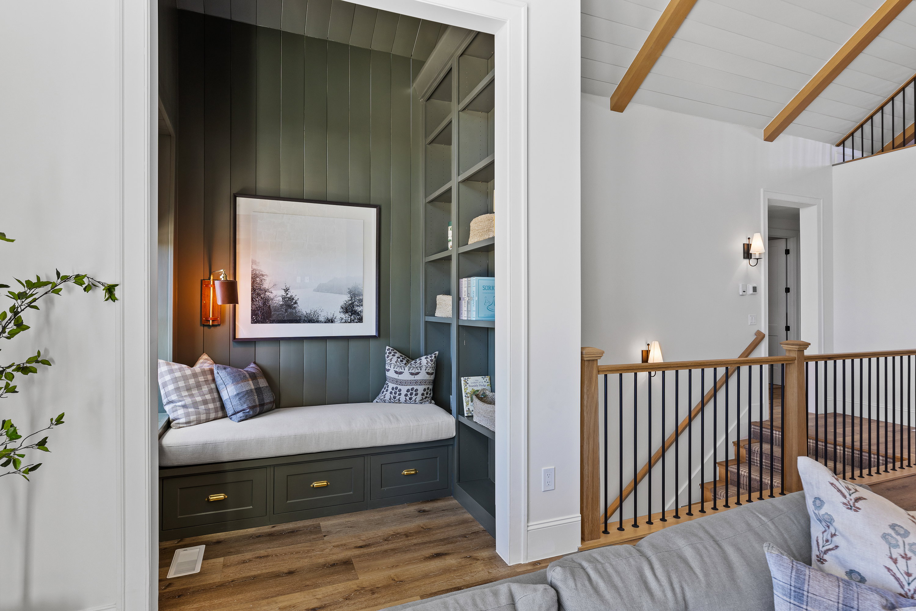 Living area featuring an upstairs landing, wood finished floors, and wooden ceiling