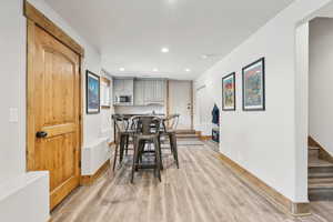 Dining space with stairway, recessed lighting, and light wood-style flooring