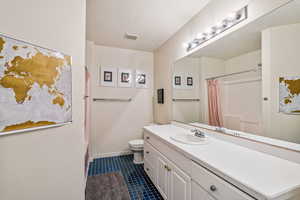 Bathroom featuring vanity, tile patterned flooring, and shower / tub combo