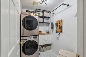 Laundry area with stacked washer / drying machine