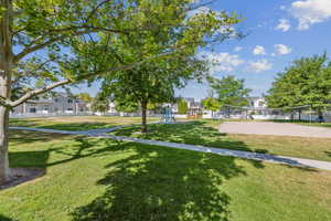 View of community featuring volleyball court, a yard, and a residential view