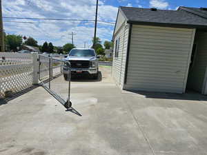 Garage featuring a gate and driveway