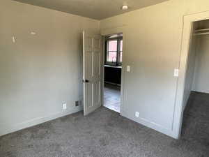 Unfurnished bedroom featuring carpet and a sink