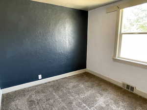Carpeted spare room with plenty of natural light