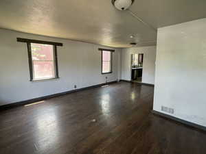 Empty room with dark wood finished floors