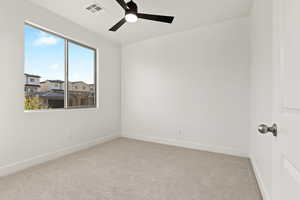 Unfurnished room featuring a ceiling fan and carpet flooring