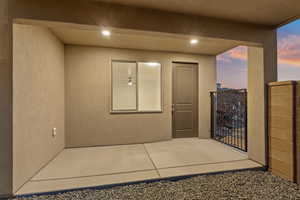 Exterior entry at dusk featuring stucco siding