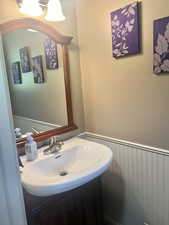 Bathroom with wainscoting and vanity