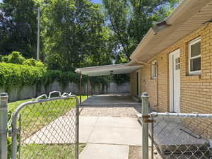 View of patio featuring a gate and a carport