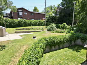 View of green lawn with a patio area