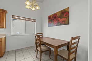 Dining room with a chandelier and light tile patterned floors