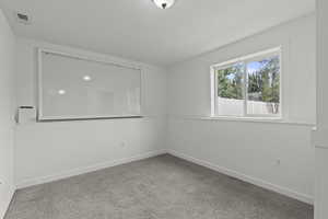 Unfurnished room featuring baseboards and carpet flooring