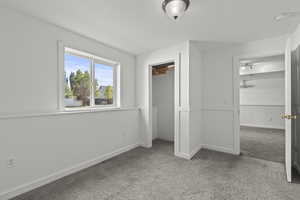 Unfurnished bedroom with carpet and a closet