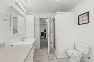 Full bathroom with vanity, tile patterned flooring, and a shower