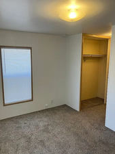 Unfurnished bedroom with a closet and carpet flooring