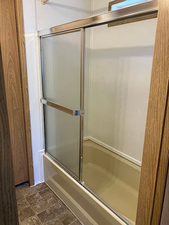 Bathroom with enclosed tub / shower combo