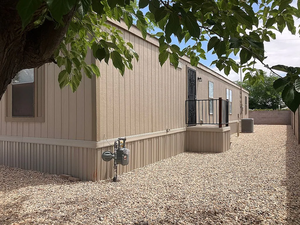 View of side of home with a central air condition unit