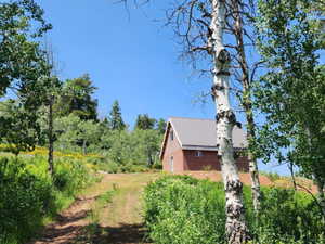 View of side of home featuring a metal roof