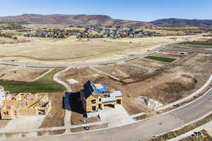 Aerial perspective of suburban area featuring a mountainous background