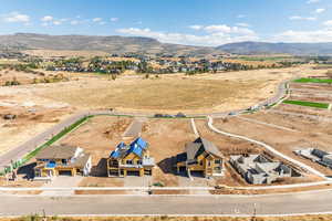 Aerial view of sparsely populated area with mountains and nearby suburban area