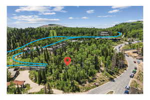 Aerial view of property and surrounding area with property boundaries highlighted and a mountain backdrop