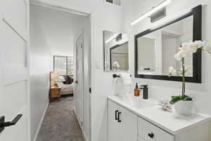 Bathroom featuring vanity and ensuite bathroom
