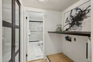 Laundry room with marble look tile flooring and washer hookup