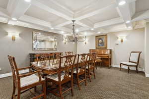 Lounge with carpet flooring, coffered ceiling, beamed ceiling, a chandelier, and crown molding