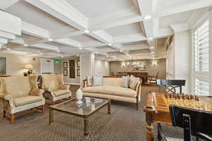 Building lounge featuring coffered ceiling, beam ceiling, crown molding, and recessed lighting