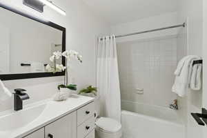 Bathroom with vanity and shower / tub combo with curtain