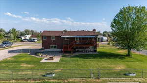 Back of house with a deck, stairs, and a fenced backyard