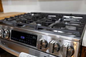 Kitchen view of stainless steel range with gas stovetop
