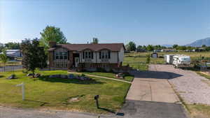 Split foyer home with a chimney and brick siding