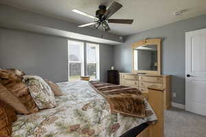 Bedroom with light carpet and ceiling fan