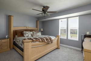 Bedroom featuring light colored carpet and a ceiling fan